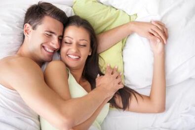 Happy guy and girl in bed